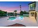 Sparkling pool and hot tub beside waterway offer a serene view, set against a twilight backdrop and swaying palms at 2589 Sun Reef Rd, Las Vegas, NV 89128