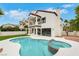 Beautiful backyard pool and spa with bright patio, and exterior view of the home at 2589 Sun Reef Rd, Las Vegas, NV 89128