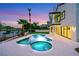 Pool with hot tub overlooks the water and landscape, set against a tranquil twilight backdrop and manicured lawn at 2589 Sun Reef Rd, Las Vegas, NV 89128