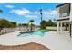 A stunning pool and spa overlooks a serene lake surrounded by lush greenery and palm trees at 2589 Sun Reef Rd, Las Vegas, NV 89128
