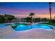 Backyard pool with a built-in spa and elegant tile work, steps lead to a relaxing space at 2589 Sun Reef Rd, Las Vegas, NV 89128