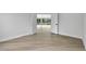 Open and airy room featuring light-colored hardwood flooring and large windows at 2589 Sun Reef Rd, Las Vegas, NV 89128