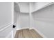 Spacious walk-in closet with built-in shelving and wooden floors, offering ample storage space at 2589 Sun Reef Rd, Las Vegas, NV 89128