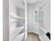 Organized walk-in closet featuring adjustable shelving and ample storage space at 2589 Sun Reef Rd, Las Vegas, NV 89128