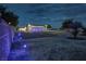 Backyard at night with string lights and colorful lights at 2650 Sagebrush Ave, Pahrump, NV 89048