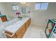 Bathroom with dual sinks, and unique tiling details around a colorful bath tub at 2650 Sagebrush Ave, Pahrump, NV 89048