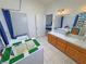 Bathroom featuring double sinks, bright mirror, shower tub, tiled countertops and wooden cabinets at 2650 Sagebrush Ave, Pahrump, NV 89048