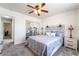 Comfortable bedroom featuring a decorative ceiling fan, bedside tables with lamps, and closet with mirrored doors at 2650 Sagebrush Ave, Pahrump, NV 89048