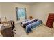 Bedroom with carpet flooring, a ceiling fan and view of the outdoors at 2650 Sagebrush Ave, Pahrump, NV 89048