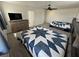 Cozy bedroom featuring soft carpet, a ceiling fan, and a dresser with mounted television at 2650 Sagebrush Ave, Pahrump, NV 89048