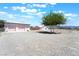 Charming home exterior with lush greenery, a well-maintained yard, and ample parking space at 2650 Sagebrush Ave, Pahrump, NV 89048
