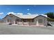 Low angle view of a single-story home with desert landscaping and light stucco at 2650 Sagebrush Ave, Pahrump, NV 89048