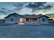 Exterior of house with a gravel yard and porch at 2650 Sagebrush Ave, Pahrump, NV 89048
