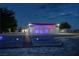 Unique property with eye-catching exterior design, lighting, and desert landscaping at twilight at 2650 Sagebrush Ave, Pahrump, NV 89048