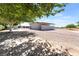 Spacious home exterior featuring shade trees, with ample parking, and durable construction at 2650 Sagebrush Ave, Pahrump, NV 89048