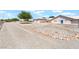 Expansive front yard featuring desert landscaping and ample parking spaces for a rural setting at 2650 Sagebrush Ave, Pahrump, NV 89048