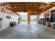 Spacious garage area featuring an open door, high ceilings, and ample room for storage or creative projects at 2650 Sagebrush Ave, Pahrump, NV 89048