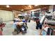 Spacious garage featuring ample storage, work space, and a large roll-up door at 2650 Sagebrush Ave, Pahrump, NV 89048