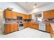 Charming kitchen showcases wooden cabinets, tiled countertops and backsplash, stainless steel appliances, and ample natural light at 2650 Sagebrush Ave, Pahrump, NV 89048