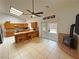 Bright kitchen features tile flooring, oak cabinets, and a cozy nook with a fireplace at 2650 Sagebrush Ave, Pahrump, NV 89048