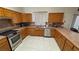 Well-lit kitchen featuring stainless steel appliances, generous counter space, and tile flooring at 2650 Sagebrush Ave, Pahrump, NV 89048