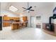 Bright kitchen features wooden cabinets, skylight, tiled floors, and an adjacent fireplace, enhancing the home's cozy charm at 2650 Sagebrush Ave, Pahrump, NV 89048
