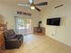 Cozy sunlit living area with tile floors, electric fireplace, and sliding glass doors to the patio at 2650 Sagebrush Ave, Pahrump, NV 89048