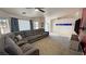 Spacious living room featuring a sectional couch and a front door view at 2650 Sagebrush Ave, Pahrump, NV 89048