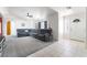 Spacious living room featuring tile and carpet flooring, a cozy sectional sofa, and ample natural light at 2650 Sagebrush Ave, Pahrump, NV 89048