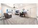 Open-concept living room with plush carpeting, ceiling fan, and view to backyard for modern living at 2650 Sagebrush Ave, Pahrump, NV 89048