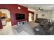 Living room showcasing a mounted TV, fireplace, and access to the kitchen area at 2650 Sagebrush Ave, Pahrump, NV 89048
