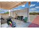 Covered patio area featuring gravel, red brick walkway, and yard equipment at 2650 Sagebrush Ave, Pahrump, NV 89048