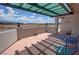 Relaxing outdoor patio with scenic views, shaded pergola, and comfortable seating area at 2650 Sagebrush Ave, Pahrump, NV 89048