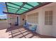 Charming outdoor patio with shaded seating area and a welcome sign at 2650 Sagebrush Ave, Pahrump, NV 89048