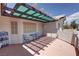 Charming patio featuring shade structure with a quaint table, chairs, and decorative shelving at 2650 Sagebrush Ave, Pahrump, NV 89048