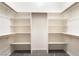 Spacious walk-in closet features ample shelving and wooden rods for efficient storage and organization at 2650 Sagebrush Ave, Pahrump, NV 89048