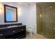 Elegant bathroom boasts a granite countertop, framed mirror, and glass-enclosed shower for a modern feel at 2700 Las Vegas Blvd # 4305, Las Vegas, NV 89109
