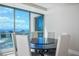Dining area featuring a dark wood table, white chairs, and floor-to-ceiling windows with city views at 2700 Las Vegas Blvd # 4305, Las Vegas, NV 89109