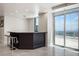 Stylish kitchen bar with counter seating and access to a balcony offering scenic city views at 2700 Las Vegas Blvd # 4305, Las Vegas, NV 89109