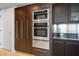 Modern kitchen featuring stainless steel appliances including built-in oven and microwave, and dark wood cabinetry at 2700 Las Vegas Blvd # 4305, Las Vegas, NV 89109