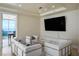 Modern living room furnished with sleek white sofas, a glass table, and large television for sophisticated lounging at 2700 Las Vegas Blvd # 4305, Las Vegas, NV 89109