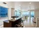 Open-concept living space features modern kitchen, dining area, and expansive windows with city views at 2700 Las Vegas Blvd # 4305, Las Vegas, NV 89109