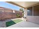 A well-maintained backyard with artificial turf, gravel landscaping, and a covered patio at 2781 Dunstan Way, Las Vegas, NV 89123