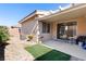 Outdoor patio area with seating, artificial grass, and a grill perfect for entertaining at 2781 Dunstan Way, Las Vegas, NV 89123