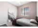 Bedroom with neutral walls, soft carpet, a ceiling fan, and a large window for natural light at 2781 Dunstan Way, Las Vegas, NV 89123