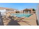 Community pool with chairs, covered tables, and landscaped surroundings at 2781 Dunstan Way, Las Vegas, NV 89123