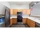 Efficient kitchen featuring stainless steel appliances, wood cabinets, and streamlined countertops at 2781 Dunstan Way, Las Vegas, NV 89123