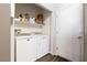 A clean laundry area with washer, dryer, storage shelf, and convenient doorway access at 2781 Dunstan Way, Las Vegas, NV 89123