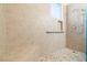 Walk-in shower with bench, grab bar, and tiled walls for accessibility and style at 2781 Dunstan Way, Las Vegas, NV 89123