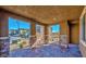 Cozy covered patio with stone pillars and brick flooring, perfect for outdoor relaxation at 2887 Starling Summit St, Henderson, NV 89044